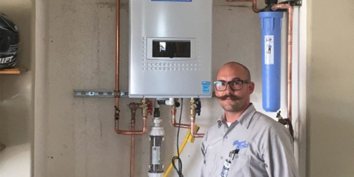 Man with mustache in front of a water heater
